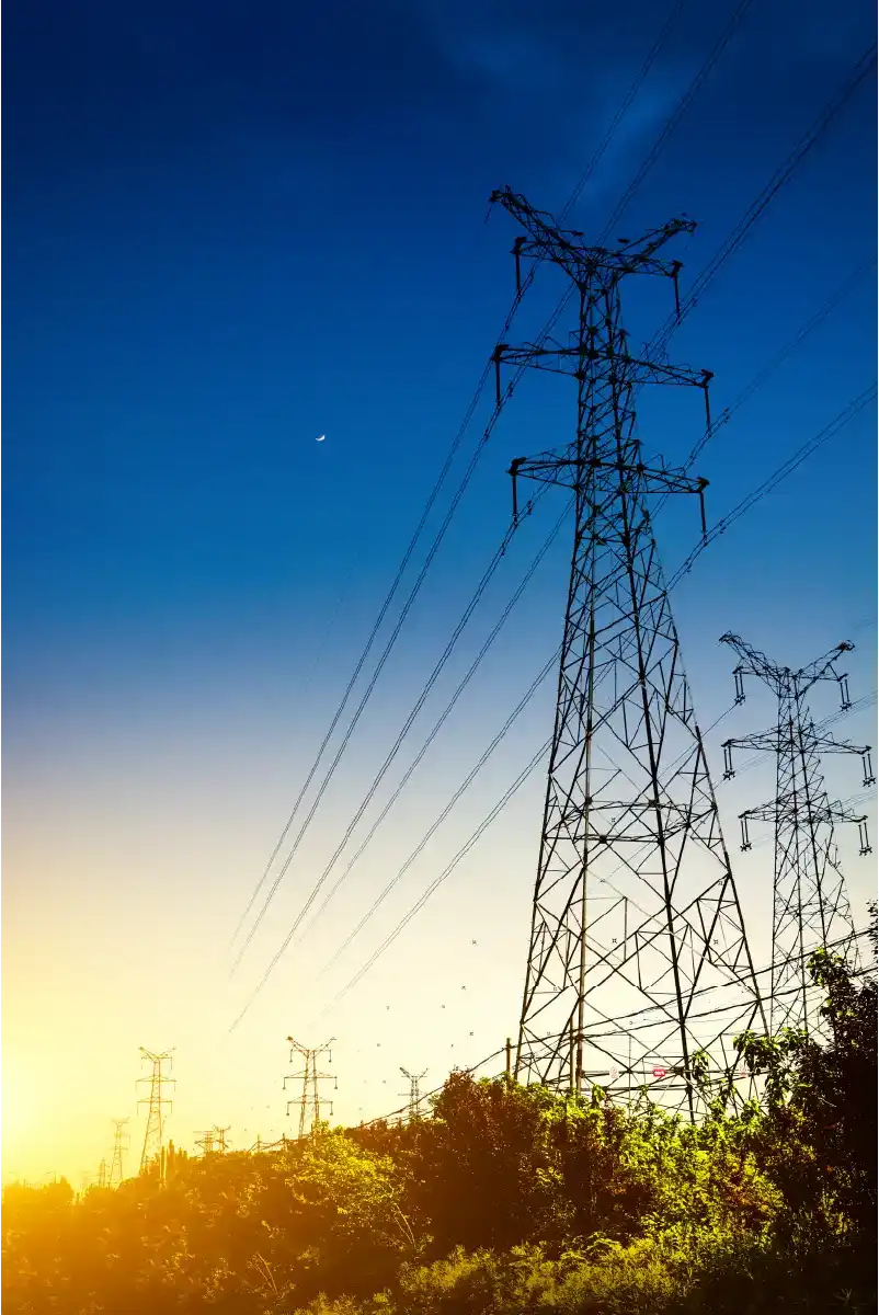 sun setting silhouette electricity pylons